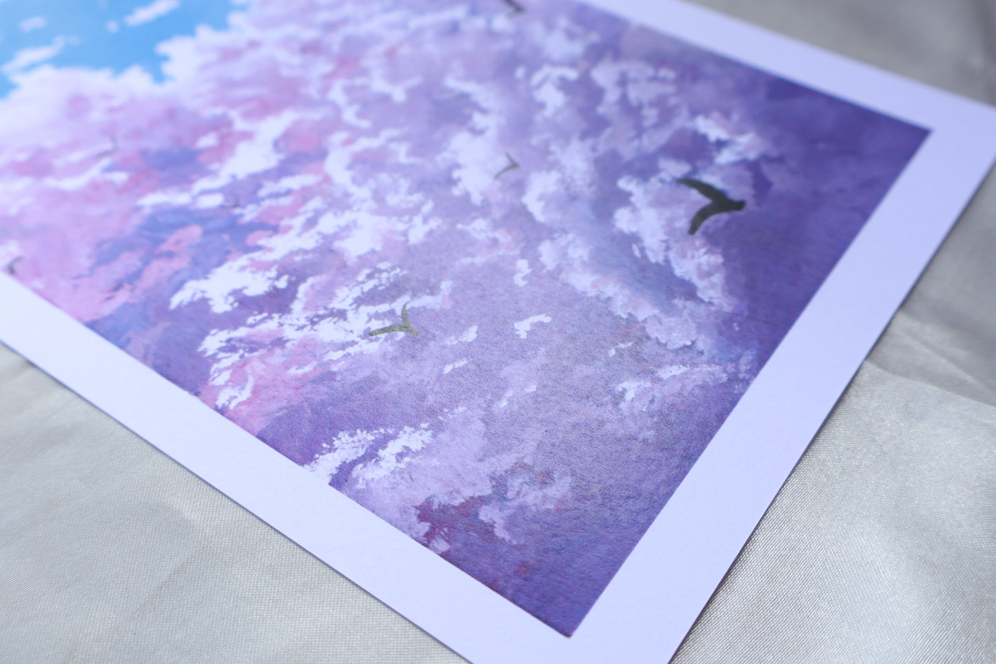 Purple cloud painting with birds in a blue background sky
