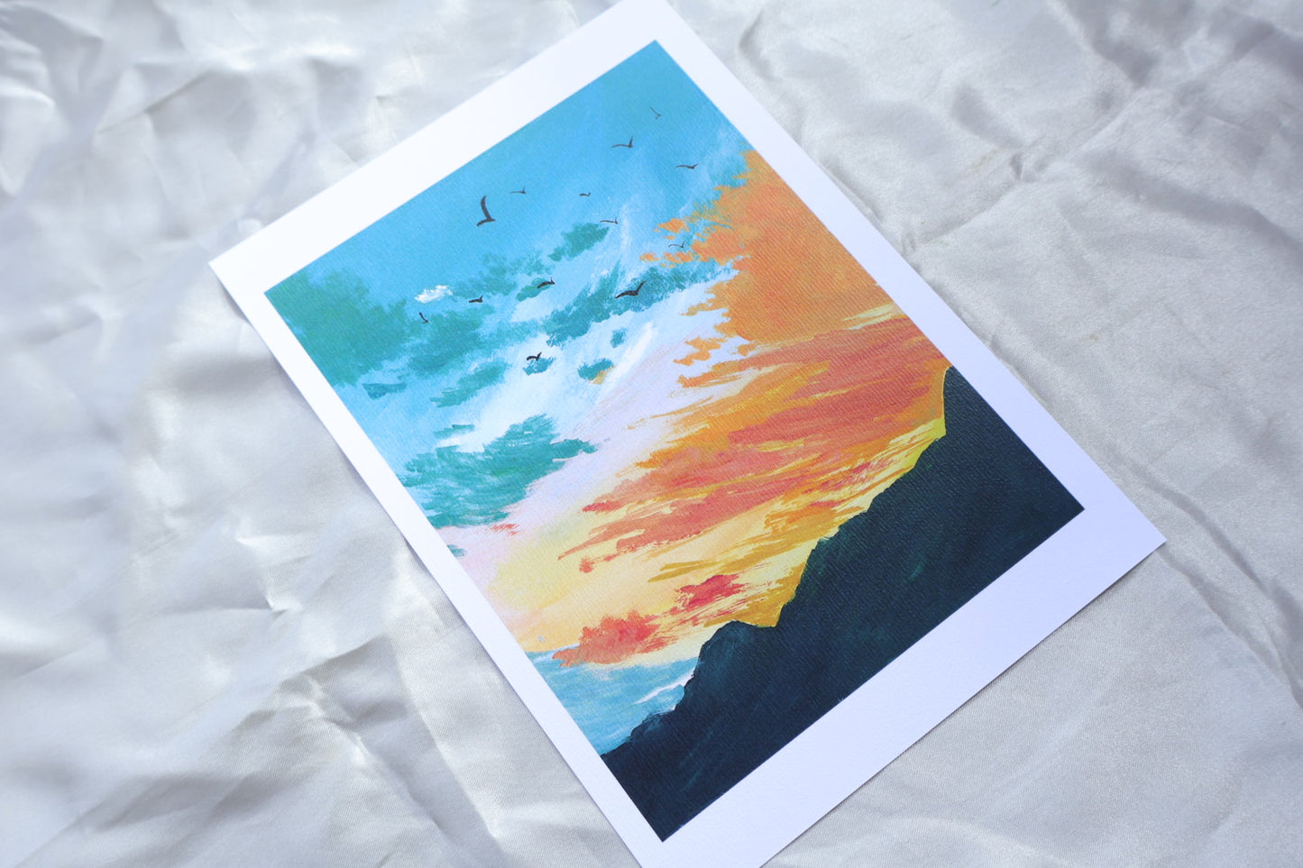 Bluish green sunset orange sky with dark green mountains
