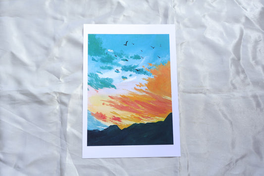 Bluish green sunset orange sky with dark green mountains
