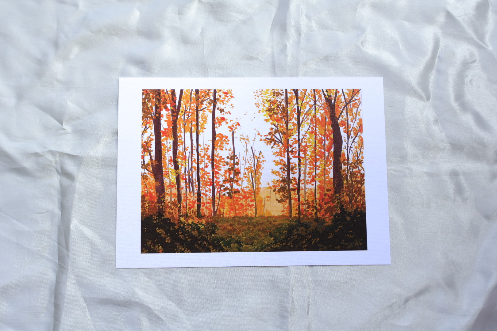 Art print of a painting of autumn vibes in the forest with orange trees and a dark green foreground
