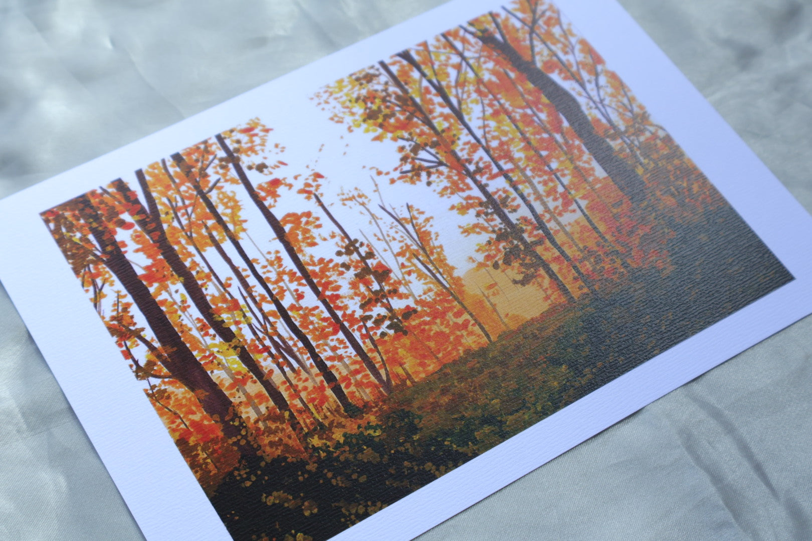 Art print of a painting of autumn vibes in the forest with orange trees and a dark green foreground
