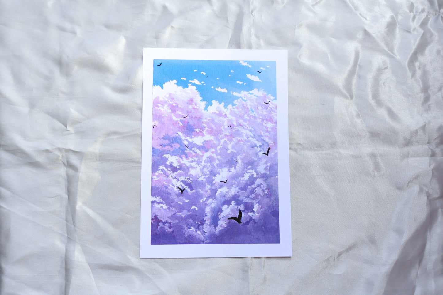 Purple cloud painting with birds in a blue background sky
