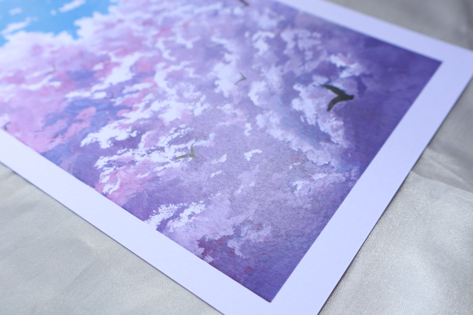 Purple cloud painting with birds in a blue background sky