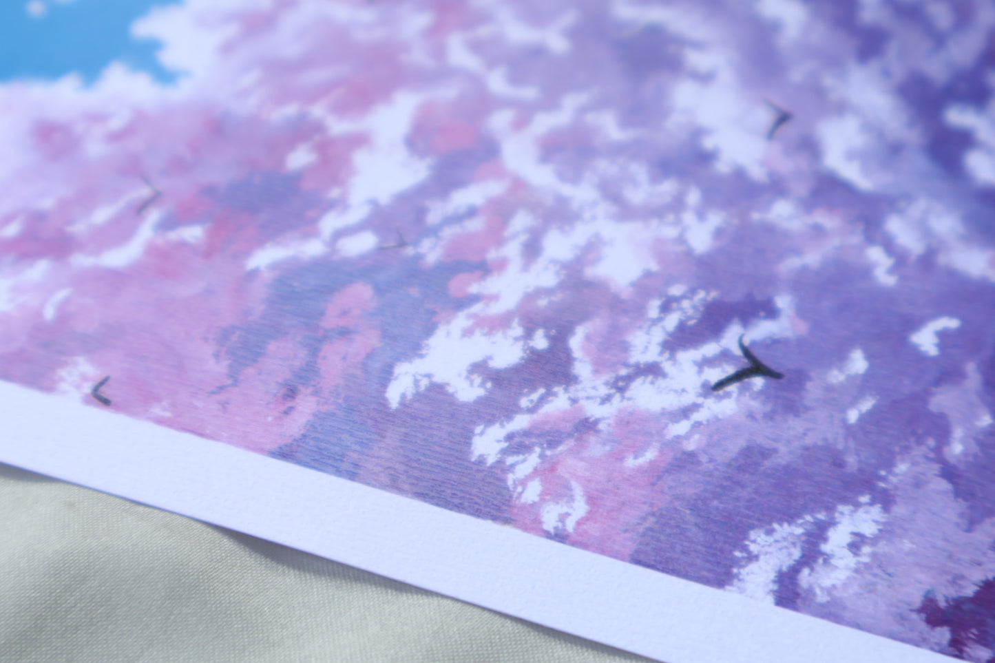 Purple cloud painting with birds in a blue background sky