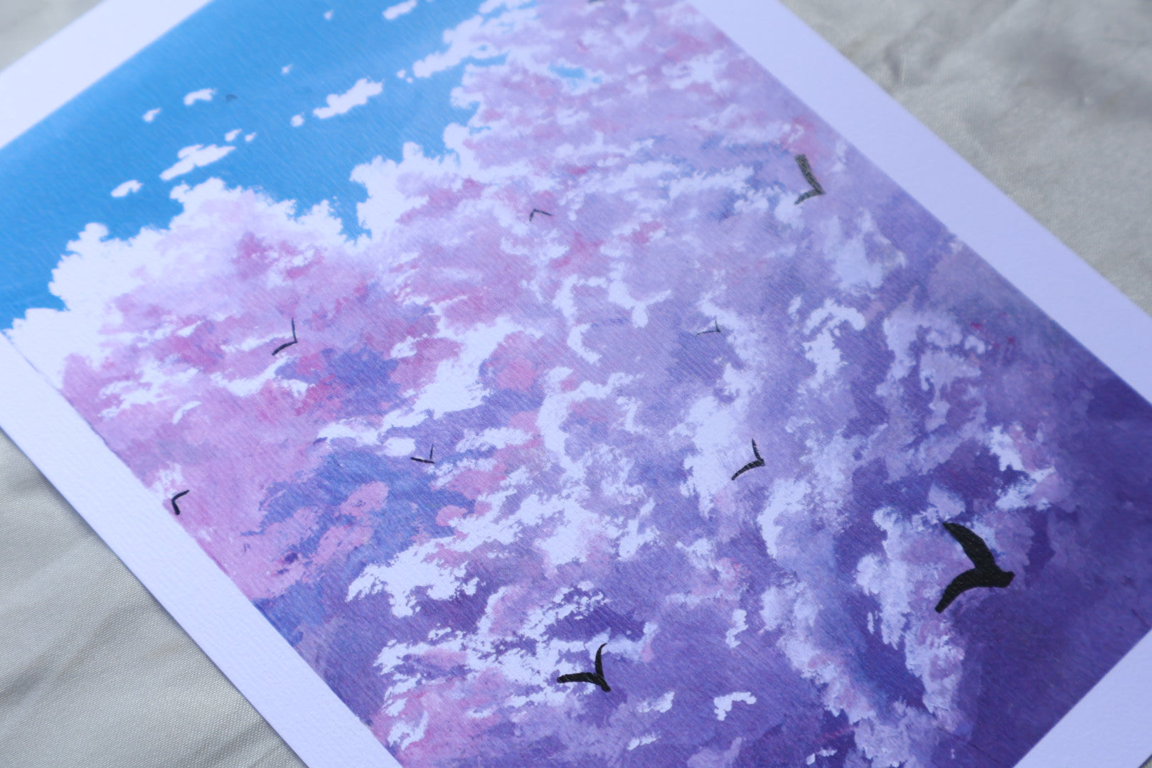 Purple cloud painting with birds in a blue background sky