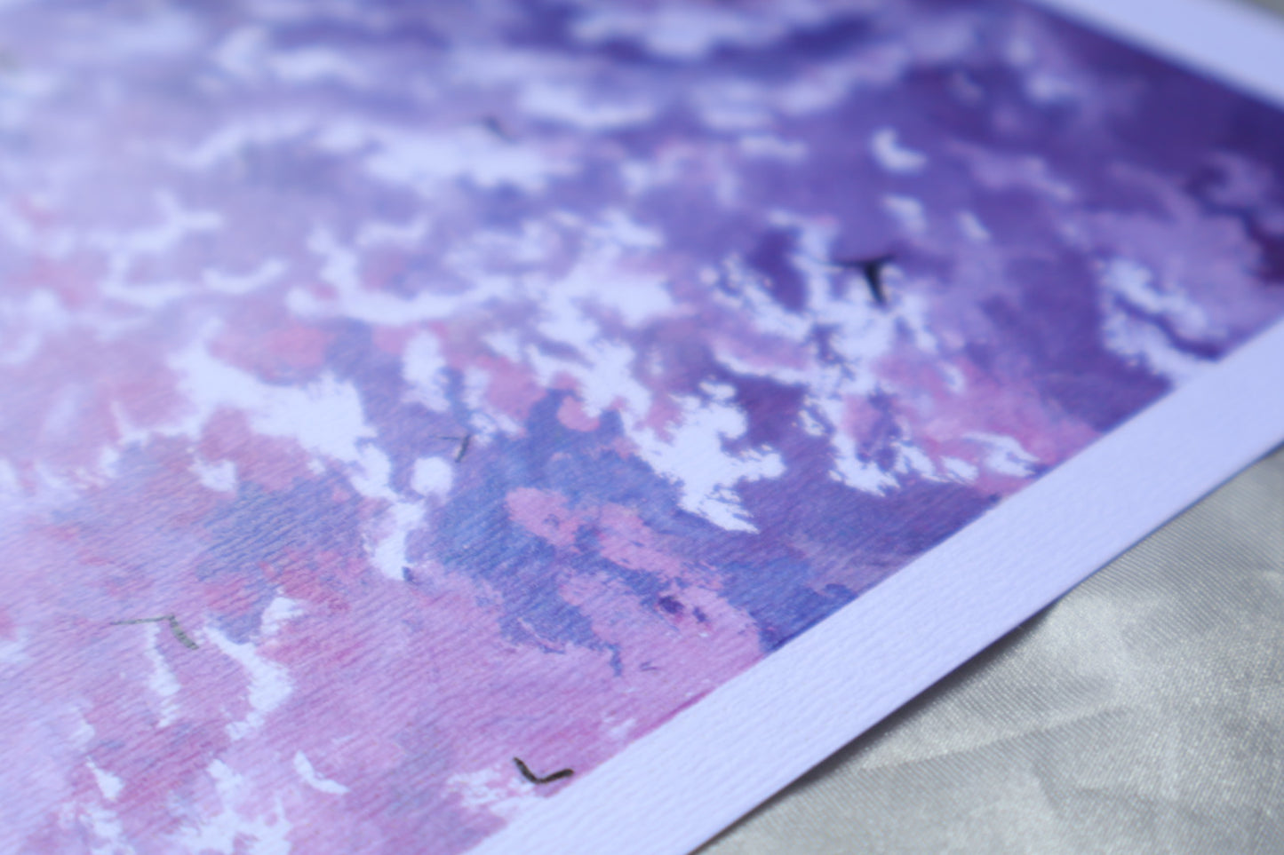 Purple cloud painting with birds in a blue background sky